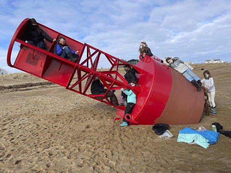 Coast Guard buoy washes ashore, could take weeks to remove